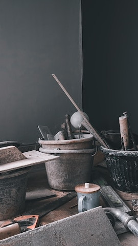 brick layering tools and buckets in the corner of a room